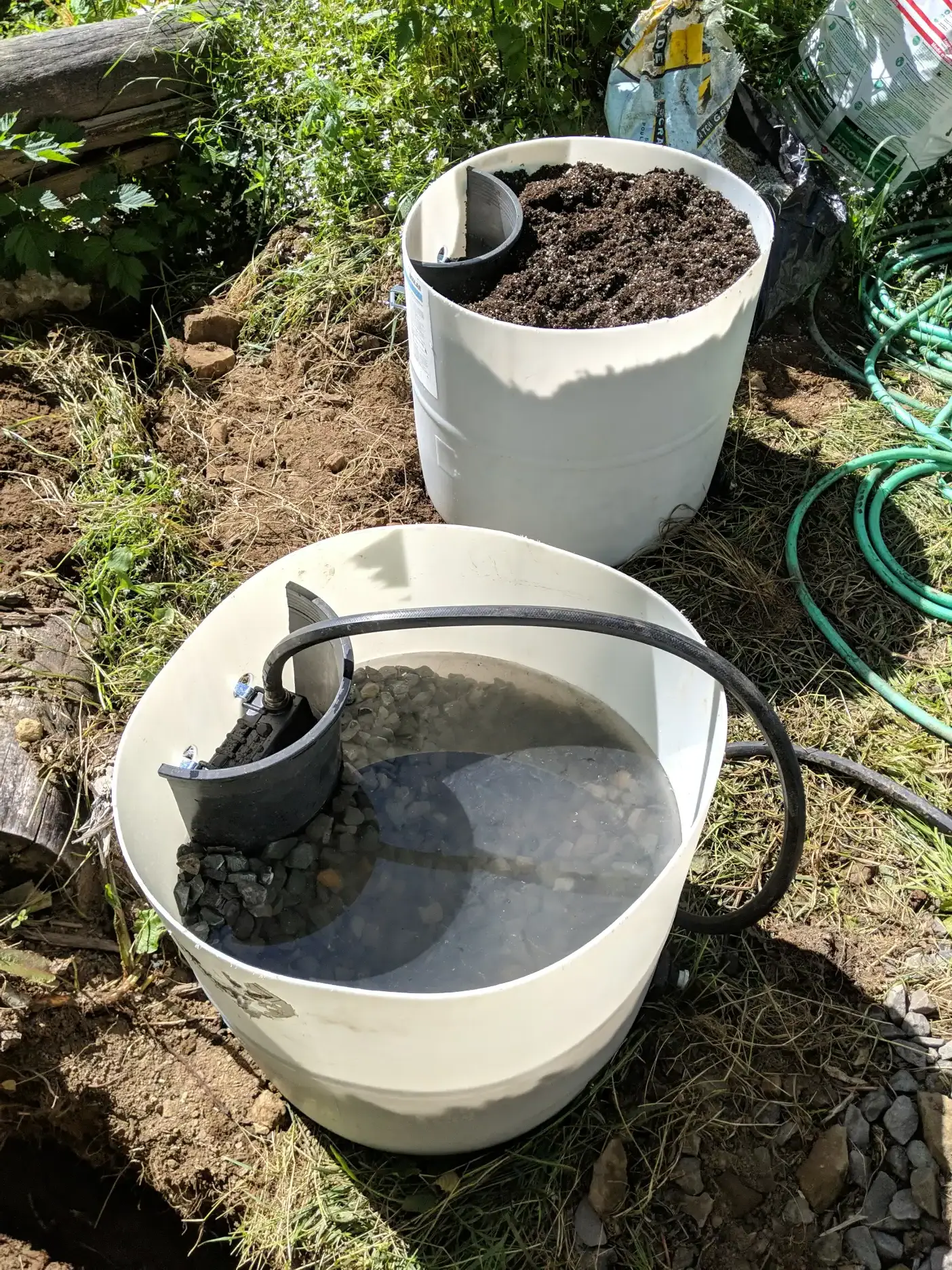 Bogs partially filled with gravel and gravel plus peat, respectively, with water level testing in progress in the one with only gravel